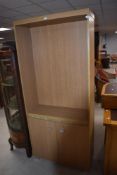 A beech laminate bookshelf with double cupboard under, dimensions approx. H180 W79 D30cm