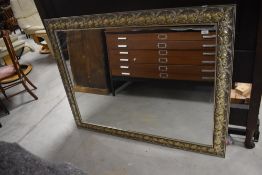 A modern wall mirror having relief ivy decoration approx. 101 x 132cm