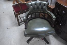 A vintage green leather swivel office chair and reproduction Chippendale style carver chair