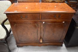 A reproduction yew wood side cabinet, dimensions H86 W107 D43cm