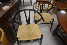 A set of four ebonised chairs , model no. CH24, manufactured by Carl Hansen & Son, Denmark, each