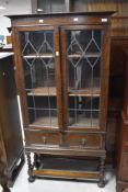 An early 20th Century glazed bookcase on twist frame , height 159cm, width 81cm