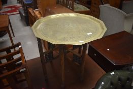 An Eastern brass tray topped folding table, of traditional octagonal form, approx width 56cm