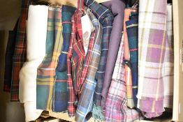 A carton of assorted tartan fabric pieces great for smaller projects and patchwork.