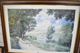 A modern print depicting a farmer herding sheep down a country lane framed and glazed 79cm x 58cm