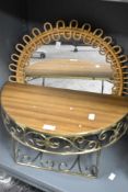 A half moon wall shelf having metal scroll base sold along with a cane bound wall mirror.