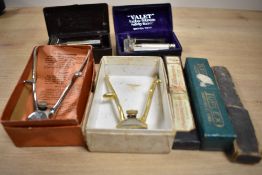 A collection of vintage shaving equipment including two Valet Auto Strop Safety Razor one in a