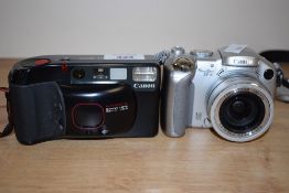 Canon Sure Shot Supreme 35mm camera with a Canon leather case and a Canon Powershot S2 IS digital