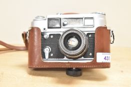 A FED-4 35mm rangefinder cameras, FED 52mm f2.8 lens and brown leather case and strap.