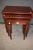 A reproduction mahogany nest of tables largest measures 51cm x 55cm x 36cm