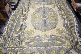 A vintage woven blanket having Southeast Asian mythological Kinnara and dragon design in blues and