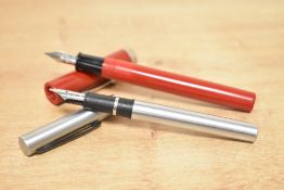 Two Sheaffer cartridge fill fountain pens. A No Nonsense in Red and a Brushed steel