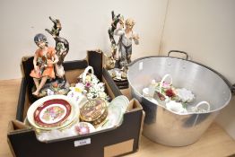 Two large vintage Capodimonte style figures depicting a male and female child amongst fruit trees,