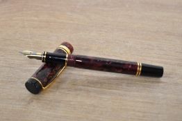 A Parker Duofold International converter fill fountain pen in Maroon Marble with one broad