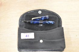 A Conway Stewart Dinkie 550 lever fill fountain pen in Blue Marble with a single cap band having