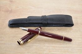 A Montblanc Meisterstuck converter fill fountain pen (CI1145124) in burgundy with gold trim having