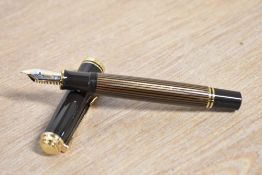 A boxed Pelikan M800 Souveran piston fill fountain pen in Brown and Black stripes having Pelikan 18C