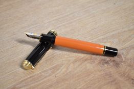 A boxed Pelikan M800 Souveran piston fill fountain pen in Orange and Black having Pelikan 18C 750