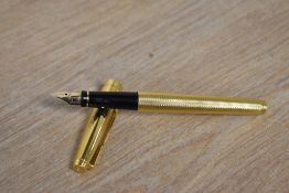 A Parker 75 converter fill fountain pen in gold Grain d'Orge pattern having Parker 585 France nib