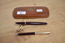 A boxed Parker 51 aerometric fill fountain pen and propelling pencil in Burgundy with gold filled