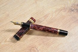 A boxed Parker Duofold Centennial converter fill fountain pen in Maroon Marble with one Broad and