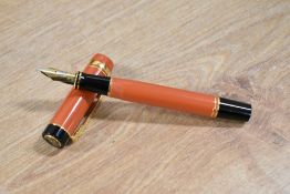 A boxed Parker Duofold Centennial converter fill fountain pen in Orange with one Broad and one