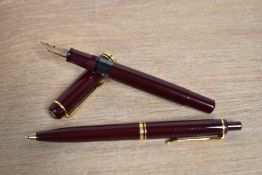 A Pelikan M400 fountain pen and Ballpoint pen in Burgundy having Pelikan 14C 585 M nib