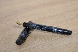 A Parker Duofold button fill fountain pen in Blue and Black marble with a narrow cap bands having