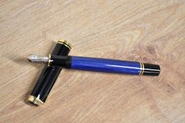 A boxed Pelikan M800 Souveran piston fill fountain pen in Blue and Black stripes having Pelikan