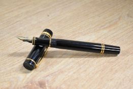 A Parker Duofold International converter fill fountain pen in Black with gold trim having Parker 18k