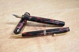 A boxed Parker Duofold button fill fountain pen in Red and Black Marble with two narrow cap bands