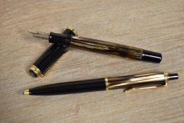 A Pelikan M400 piston fill fountain pen and ballpoint pen in Tortoise Brown Striped and Black having