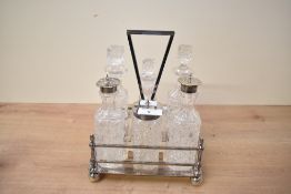 A late 19th to early 20th century silver plated cruet set, comprising a decorative stand fitted with