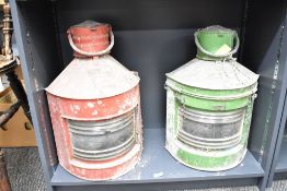 Two large 19th to early 20th-century galvanised metal ship’s port lanterns, comprising one green and