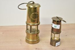 A pair of 20th century brass miners’ lamps, comprising a Hockley Lamp & Lime Light Company example