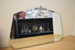 A 20th-century Art-Deco mirror, having a decorated gilded top and a framless bevelled mirror, 56cm