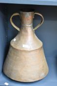 A large late 19th to early 20th-century copper ewer, of broad body with twin sculpted handles,