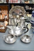 A selection of hammered pewter items comprising stein, four piece tea set and circular tray with