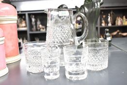 A Cumbria cut-crystal jug and two tumblers, the jug with applied Cumbria Crystal label, sold