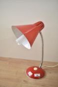 A mid 20th-century De La Mare red gooseneck tabletop lamp, 34cm at full extension, working