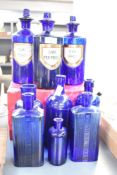 A selection of Victorian apothecary cobalt blue glass bottles, to include a set of three with
