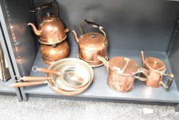 A selection of late 19th to 20th-century copperware, to include three teapots, a set of three wood-