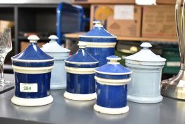 A group of six 19th century pottery apothecary jars, each with finial topped and spreading