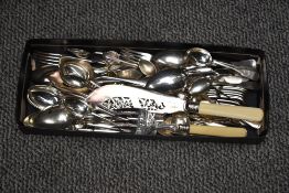 A small selection of silver-plated cutlery and flatware including spoons, dessert spoons, forks