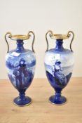 Two early 20th-century Royal Doulton ceramic Blue Children seriesware vases with twin handles,
