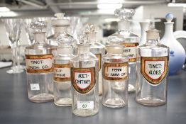A set of eight Victorian E. S. & Company apothecary bottles, of clear glass cylindrical forms with