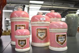 A group of five Victorian gilt embellished puce pottery apothecary/chemist jars, two large, one