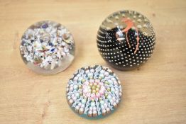 A group of three 20th century art glass paperweights, comprising a Caithness 'Polka' example with