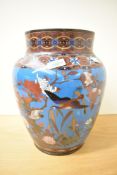 A large Chinese Cloisonne enamel vase, of baluster form decorated with birds and blossoms within