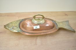 A vintage copper and brass fish-shaped serving dish, the body formed in a hammered copper with